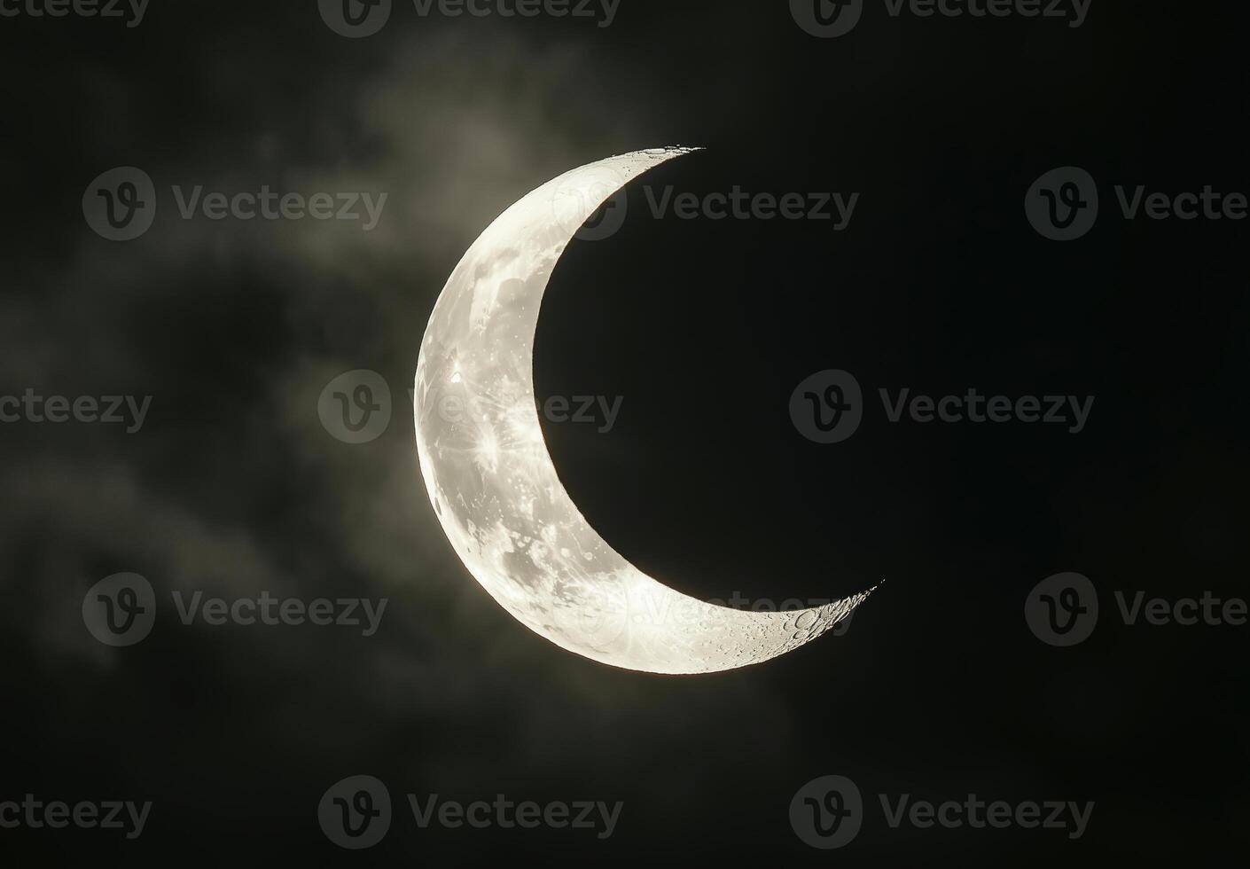crescent moon glowing above clouds 3 photo