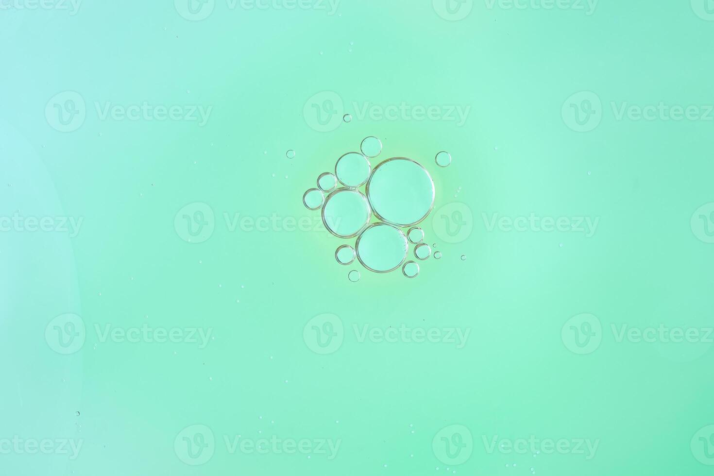 Minimalist oil Bubbles Cluster on Mint Green Background. Macro photo
