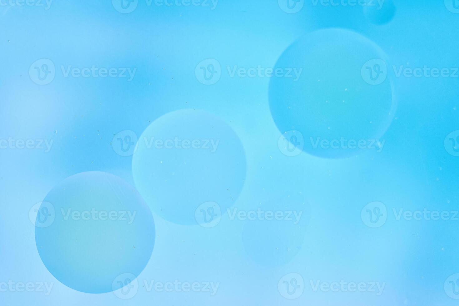 Delicate blue abstract background with numerous air bubbles floating in a soft gradient. photo
