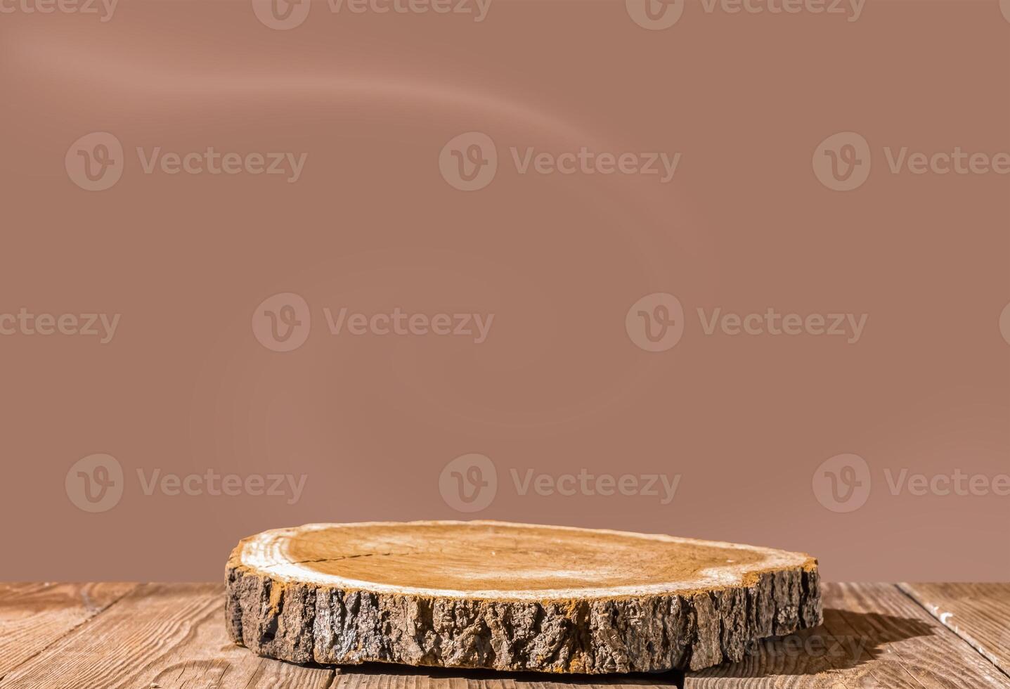 Slice wooden podium round saw cut of a tree on a mocha mousse color background. Still life for the presentation of products. photo