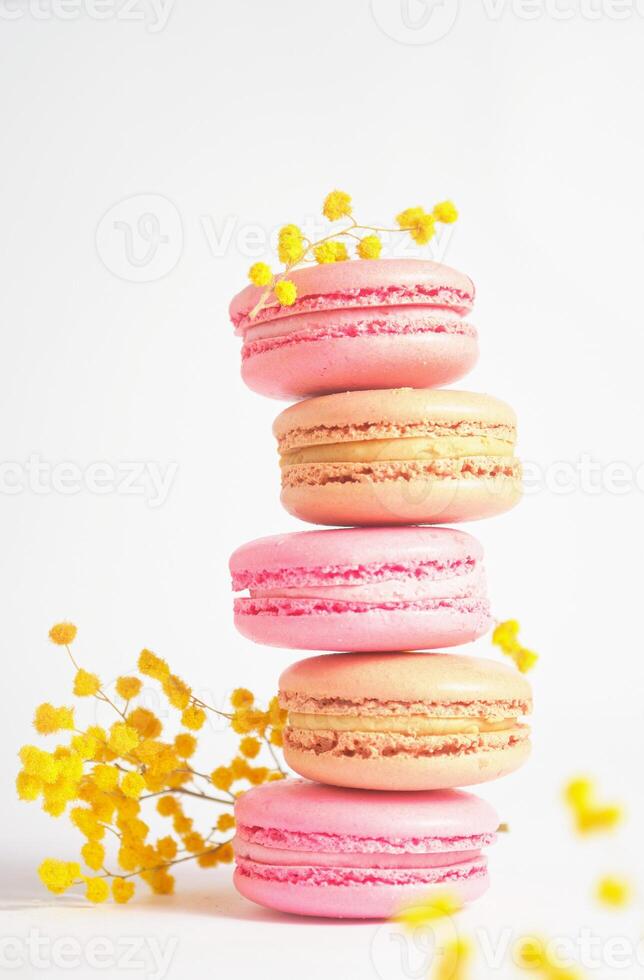 Colorful Macaron Stack with Yellow Mimosa Accent. Photo aesthetics