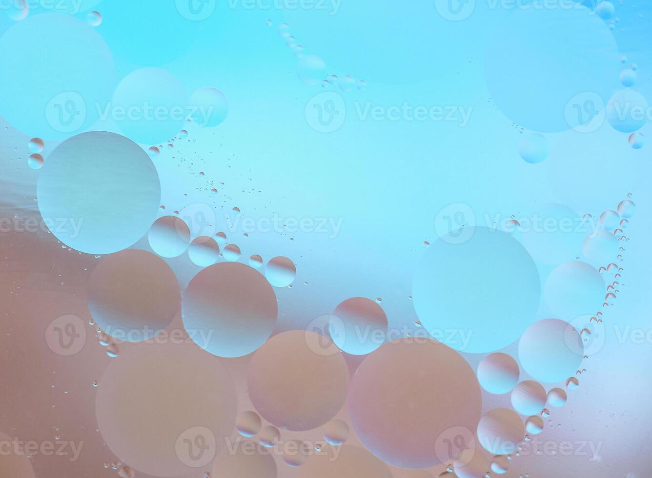 Beautiful cosmetic background. Beige blue abstract oil bubbles or face serum background. photo