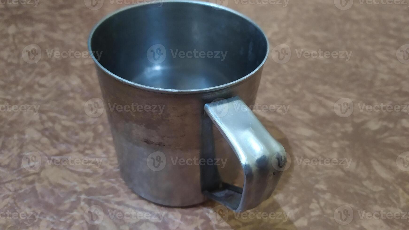 a metal mug with a handle on it photo