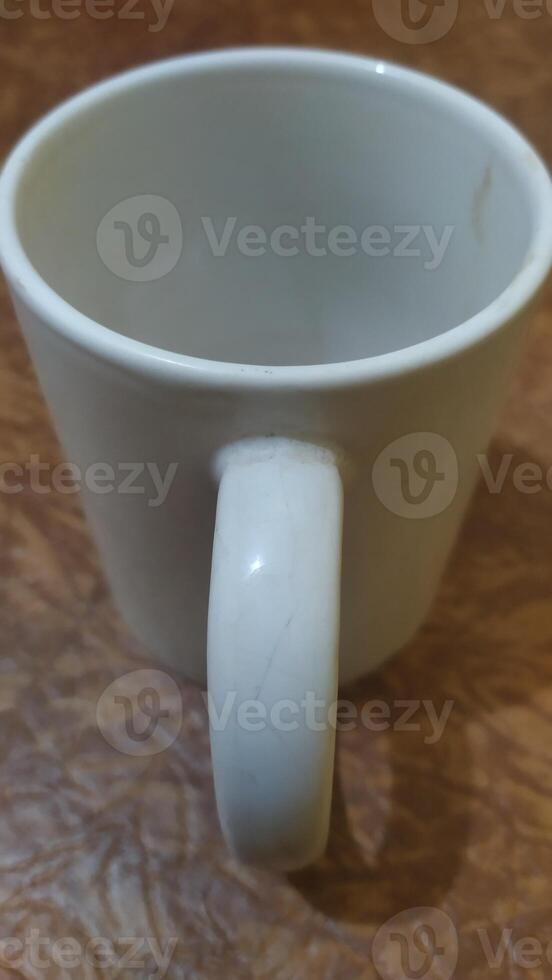 a white coffee cup with a handle on it photo