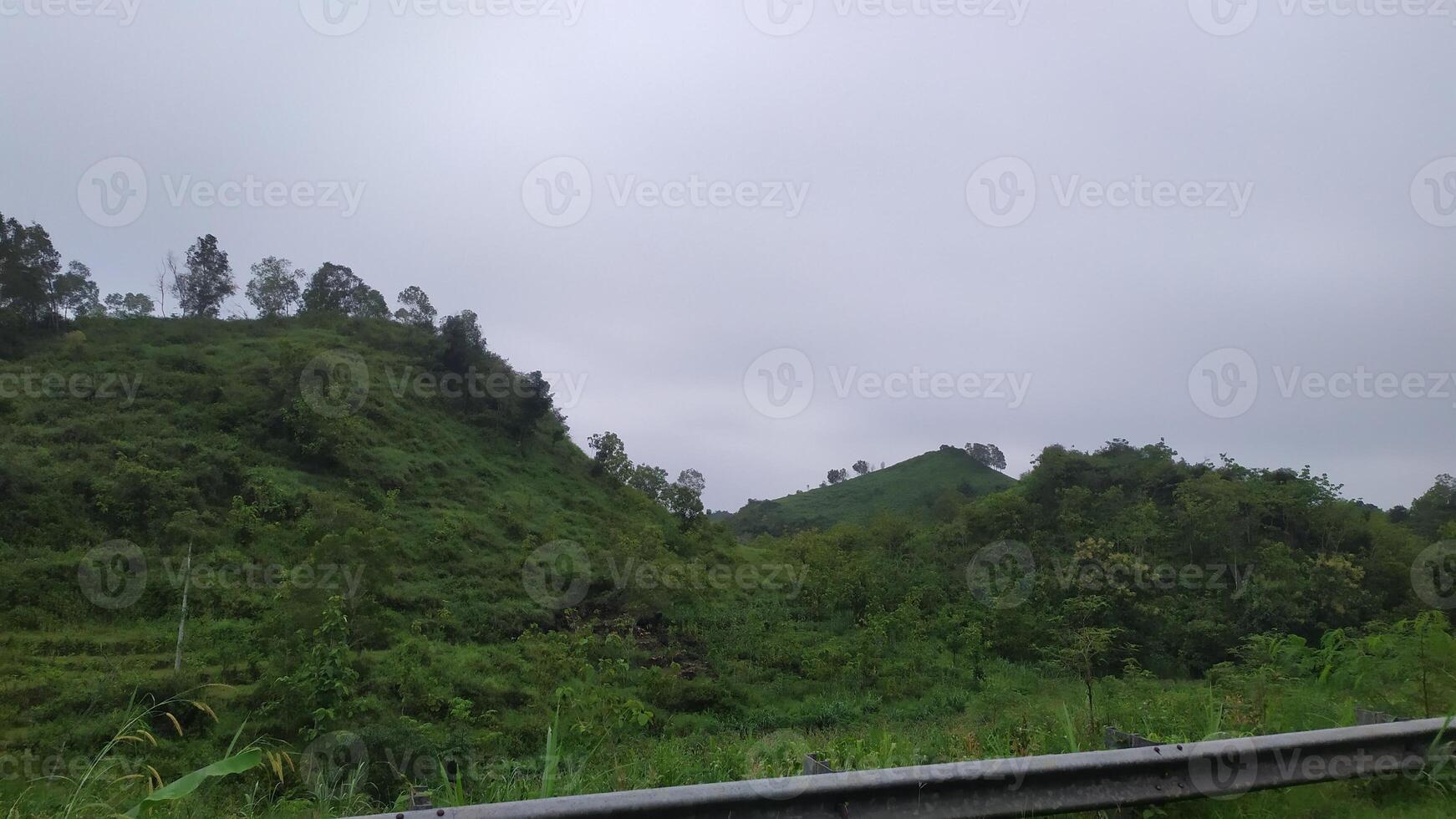 a view of a road with a mountain in the background photo