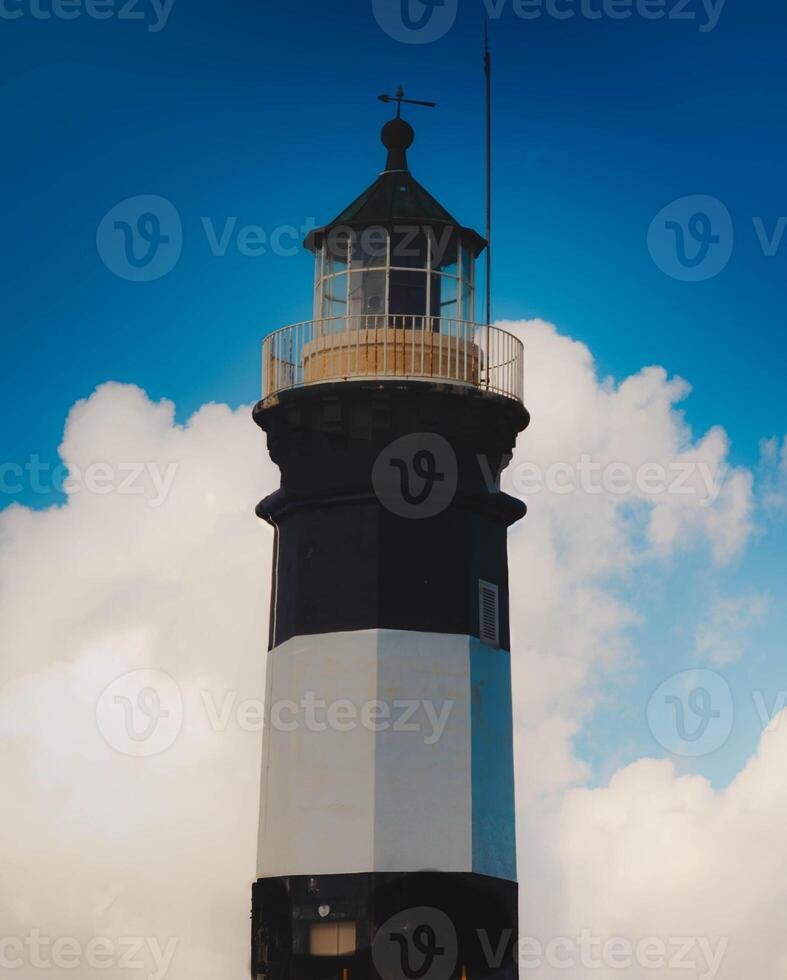 Majestic Lighthouse Against Blue Sky photo