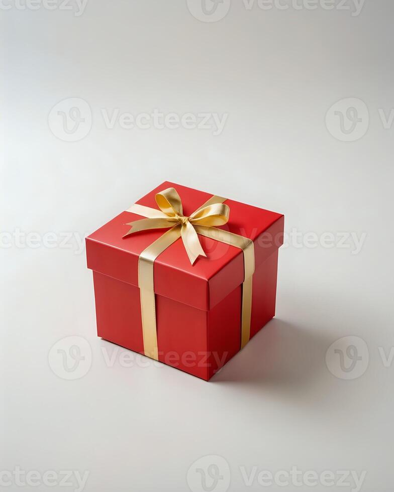 A fancy, small red gift box with a yellow ribbon photo
