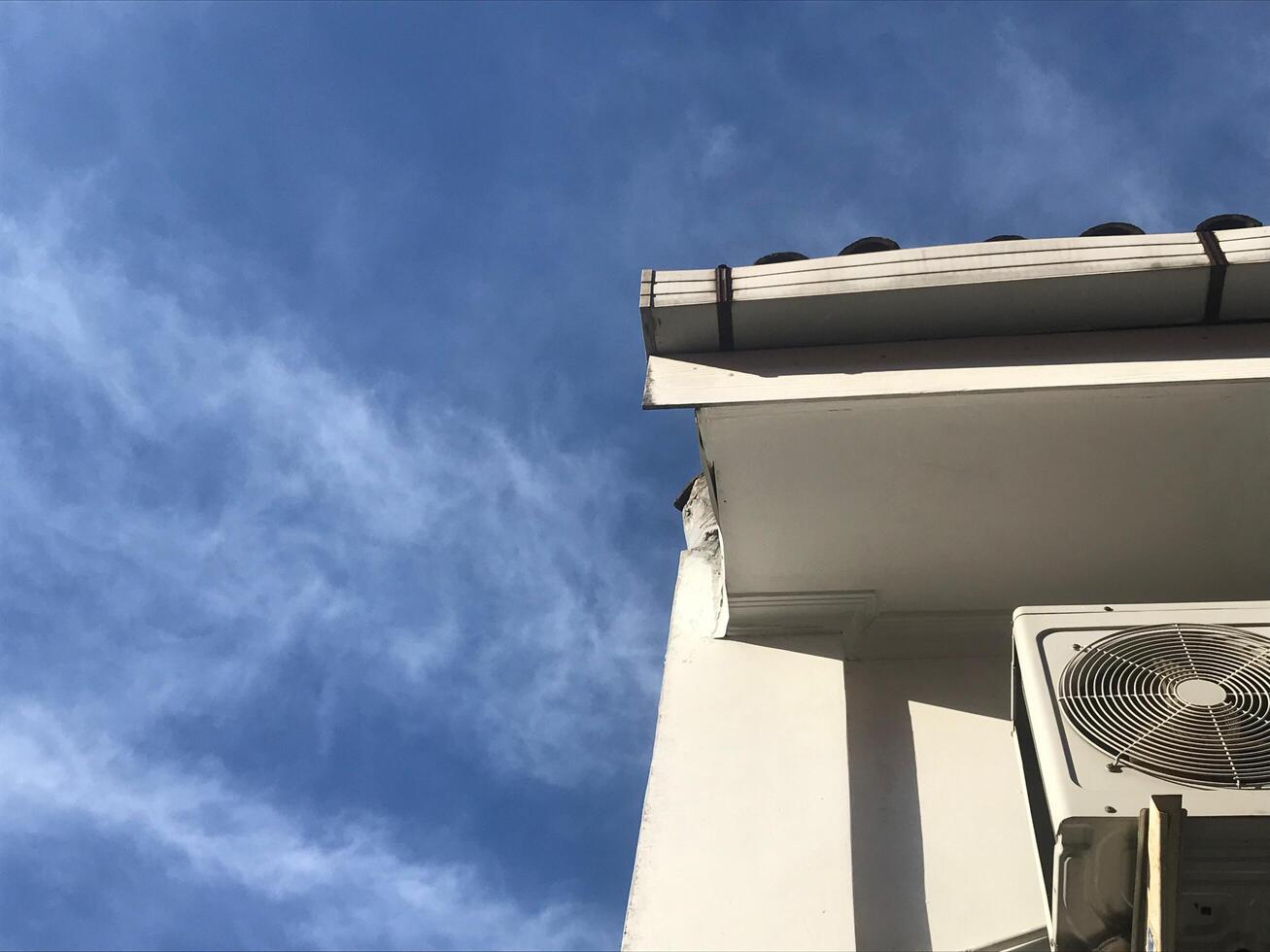 White building with a window air conditioner photo