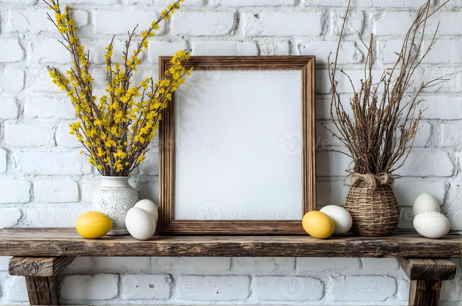 Decorative spring display featuring yellow flowers, eggs, and an empty frame for mockup on a rustic wooden shelf against a white brick wall photo