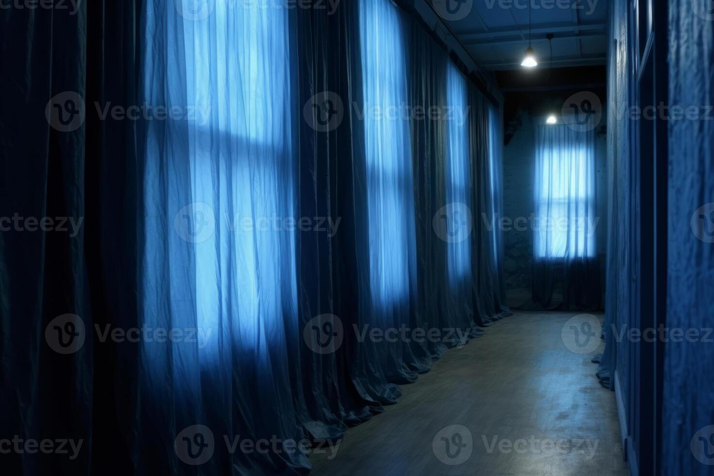 Long corridor with windows and blue curtains to the floor. Two lamps. Parquet floor. photo