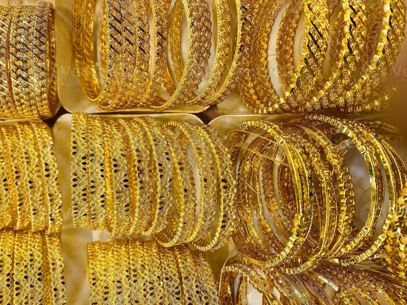 Gold Bracelets. jewelry for sale in market. elegant gold jewelry in the largest market. Rows of gold bracelets photo