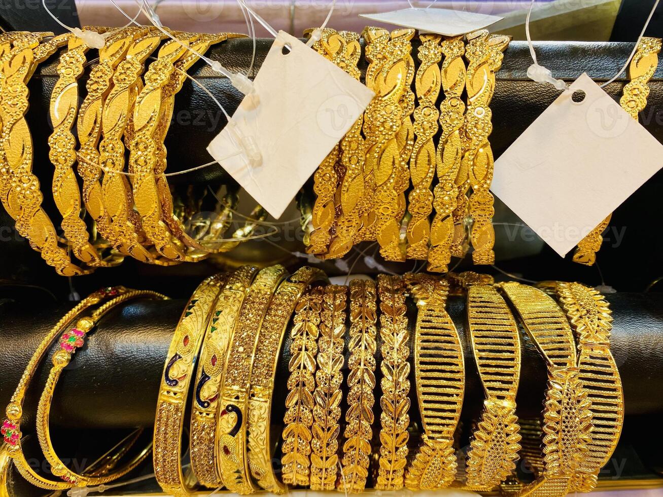 Gold bangles for sale at a market in dubai photo