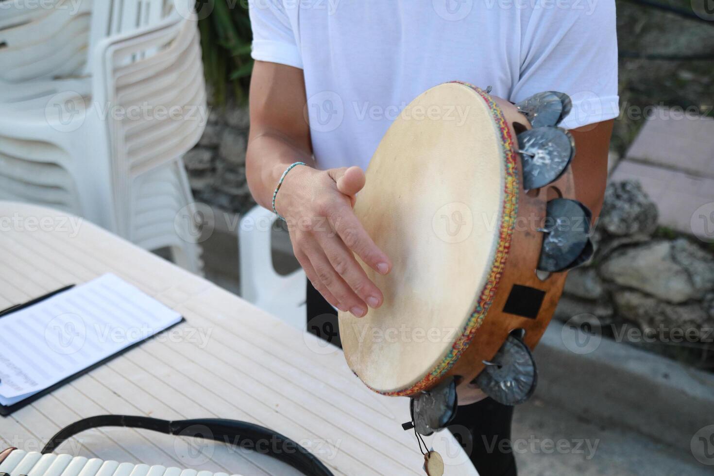 Happy Tambourine Player Performing in Fields photo