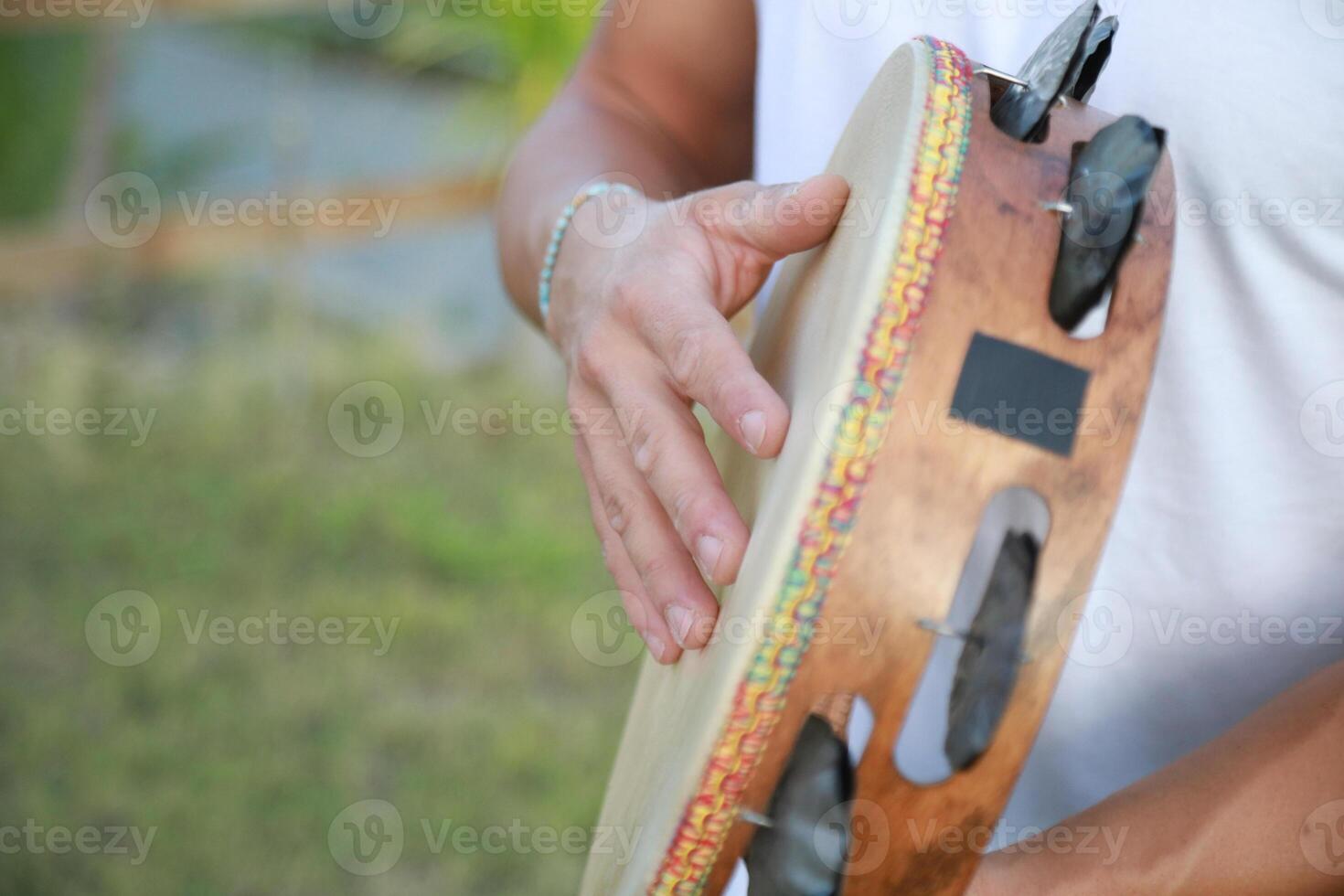 Joyful Tambourine Beats in Rolling Countryside photo