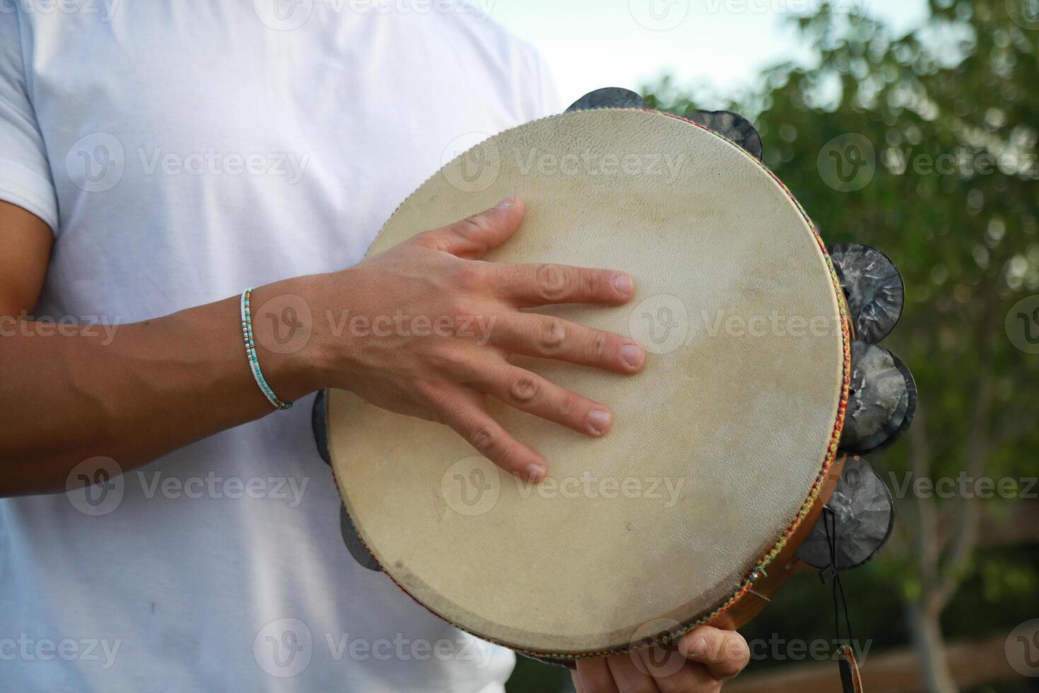 Joyful Tambourine Beats in Rolling Countryside photo