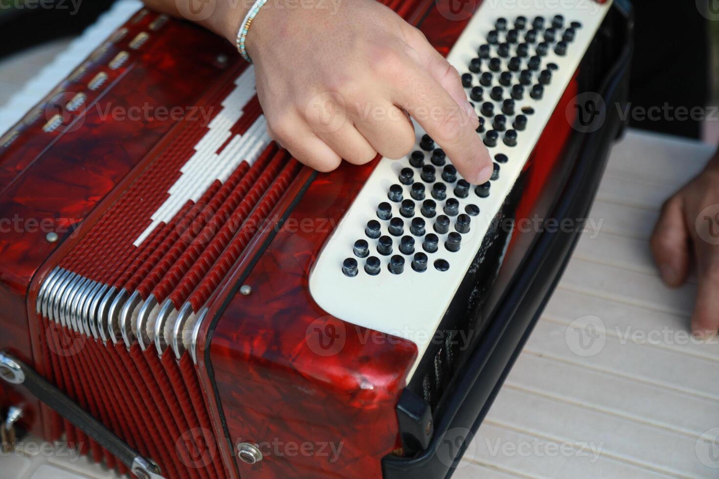 Man Testing All The Buttons Of His Accordion photo