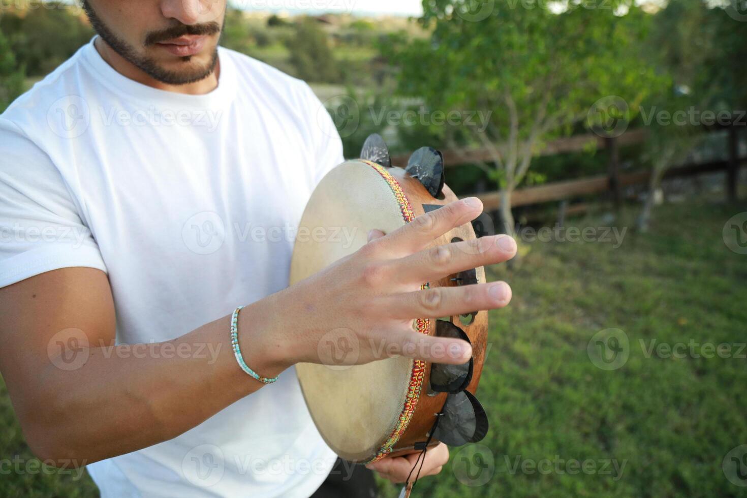 Skilled Tambourine Player in Vast Countryside photo
