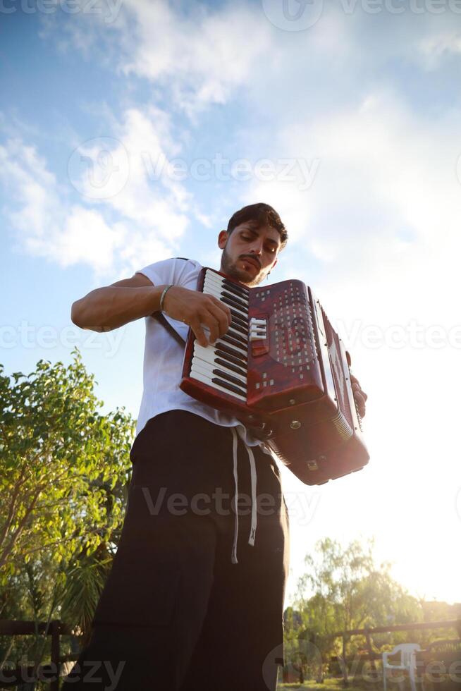 Dynamic Accordionist in Nature Embrace photo