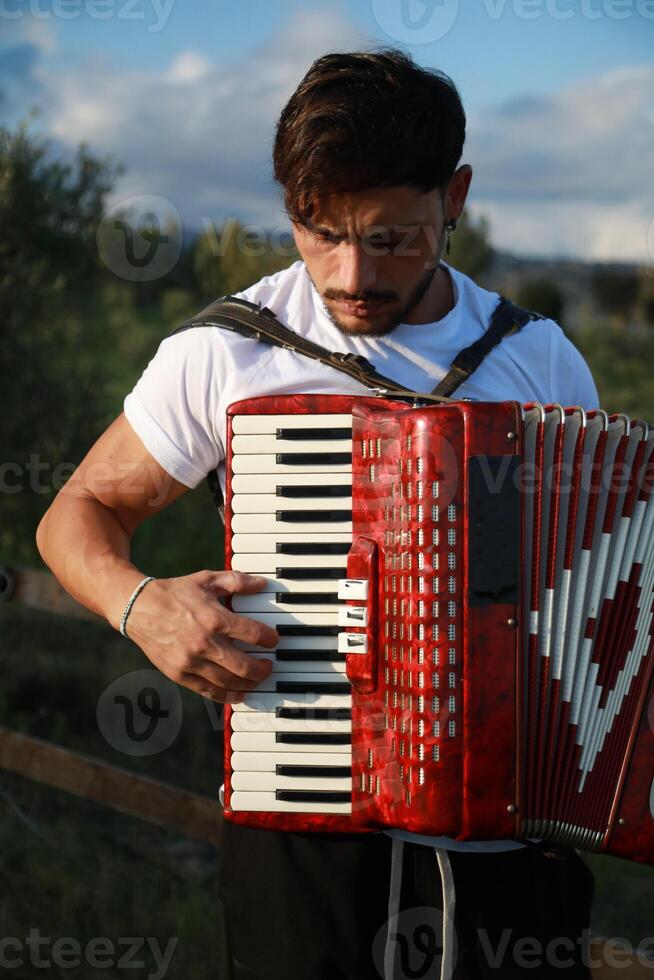 Dynamic Accordionist in Nature Embrace photo