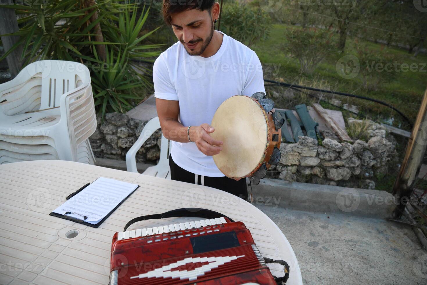 Happy Tambourine Player Performing in Fields photo