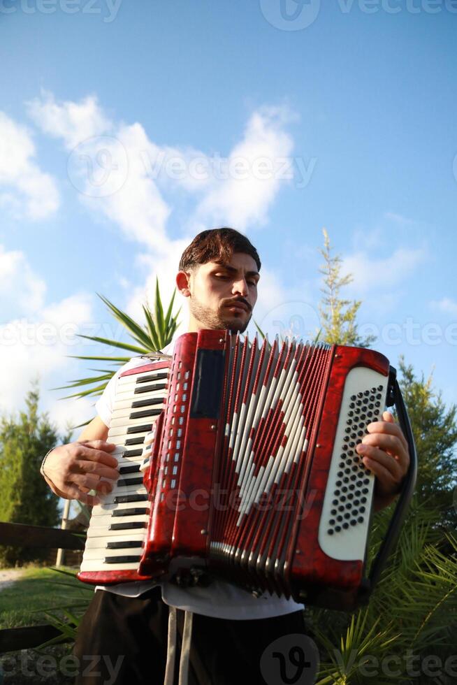 Virtuoso Accordionist Performing Amidst Nature photo