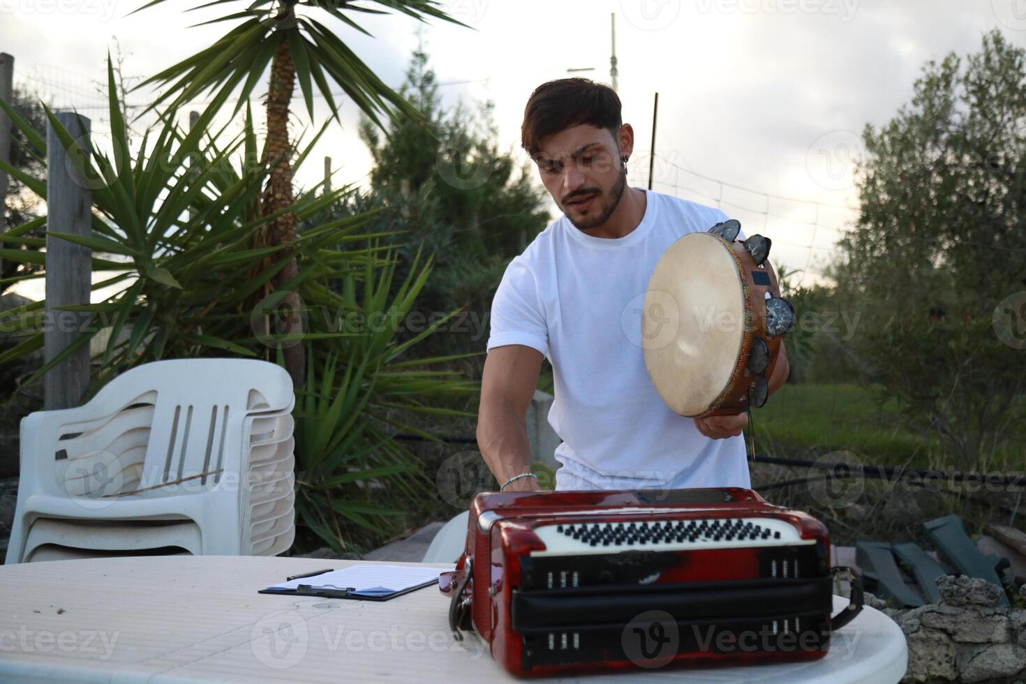Happy Tambourine Player Performing in Fields photo