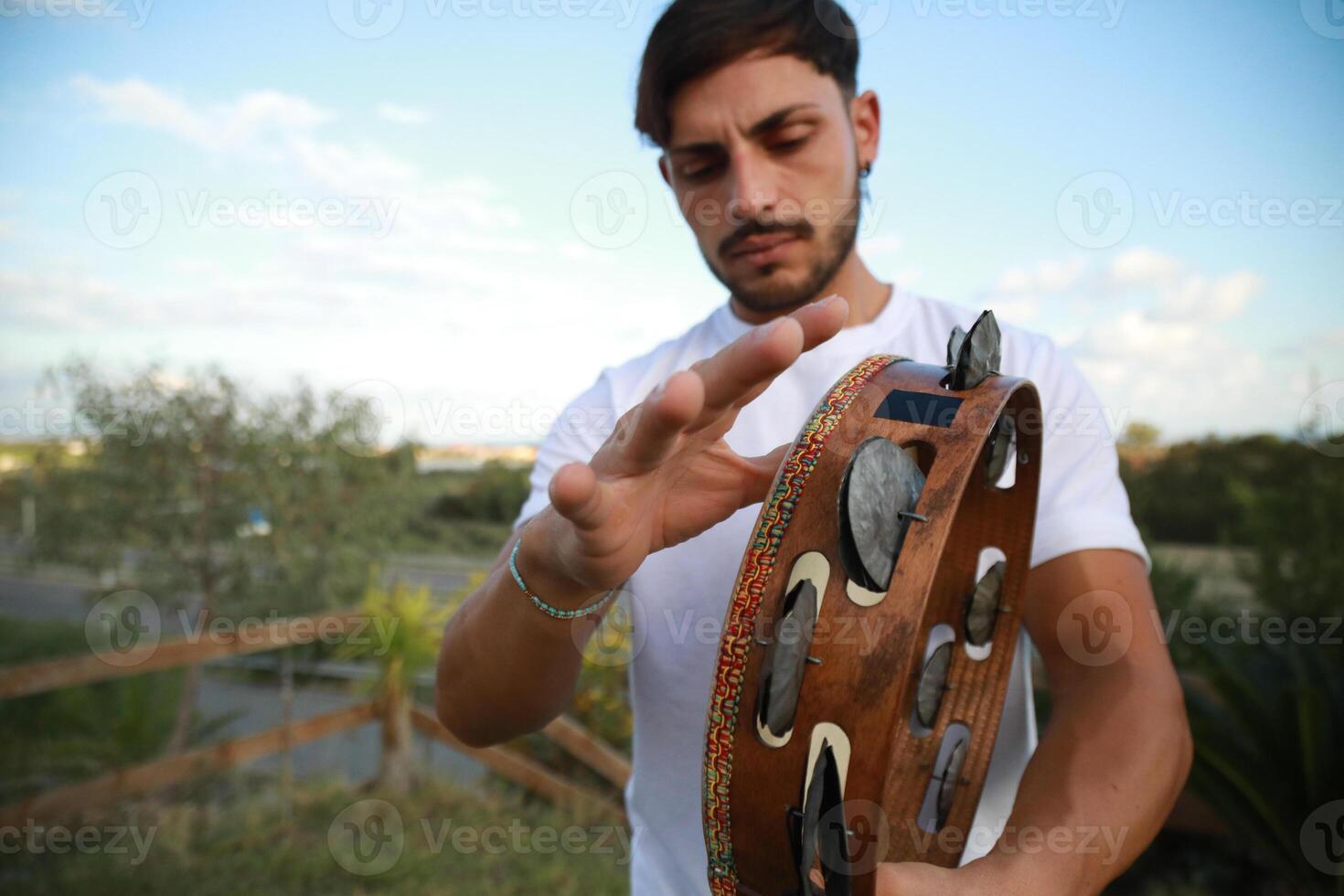 Skilled Tambourine Player in Vast Countryside photo