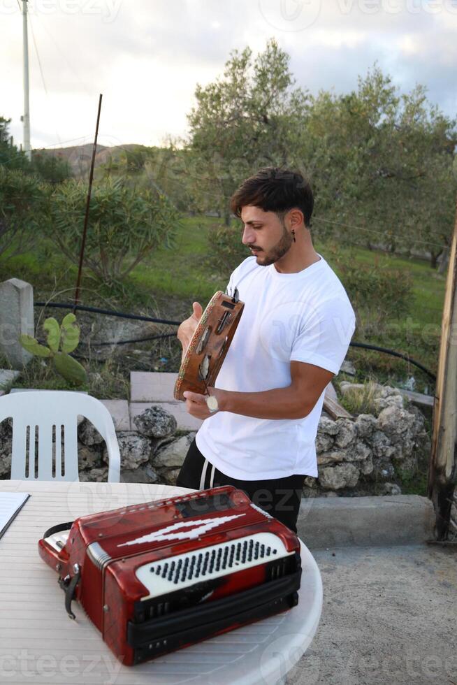 Happy Tambourine Player Performing in Fields photo