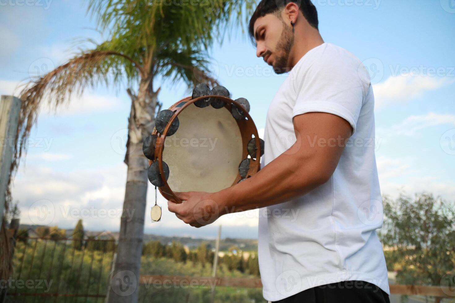 Skilled Tambourine Player in Vast Countryside photo