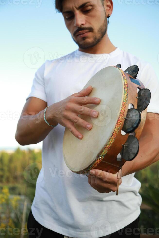 Joyful Tambourine Beats in Rolling Countryside photo