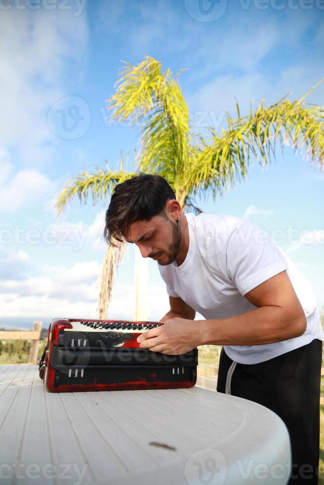 Man Testing All The Buttons Of His Accordion photo