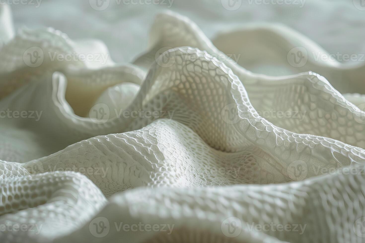 White lace fabric forming elegant waves in close up photo