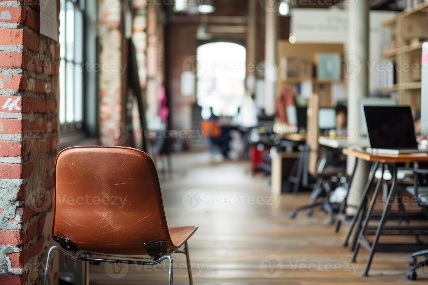 Empty chair standing in a busy open space office photo