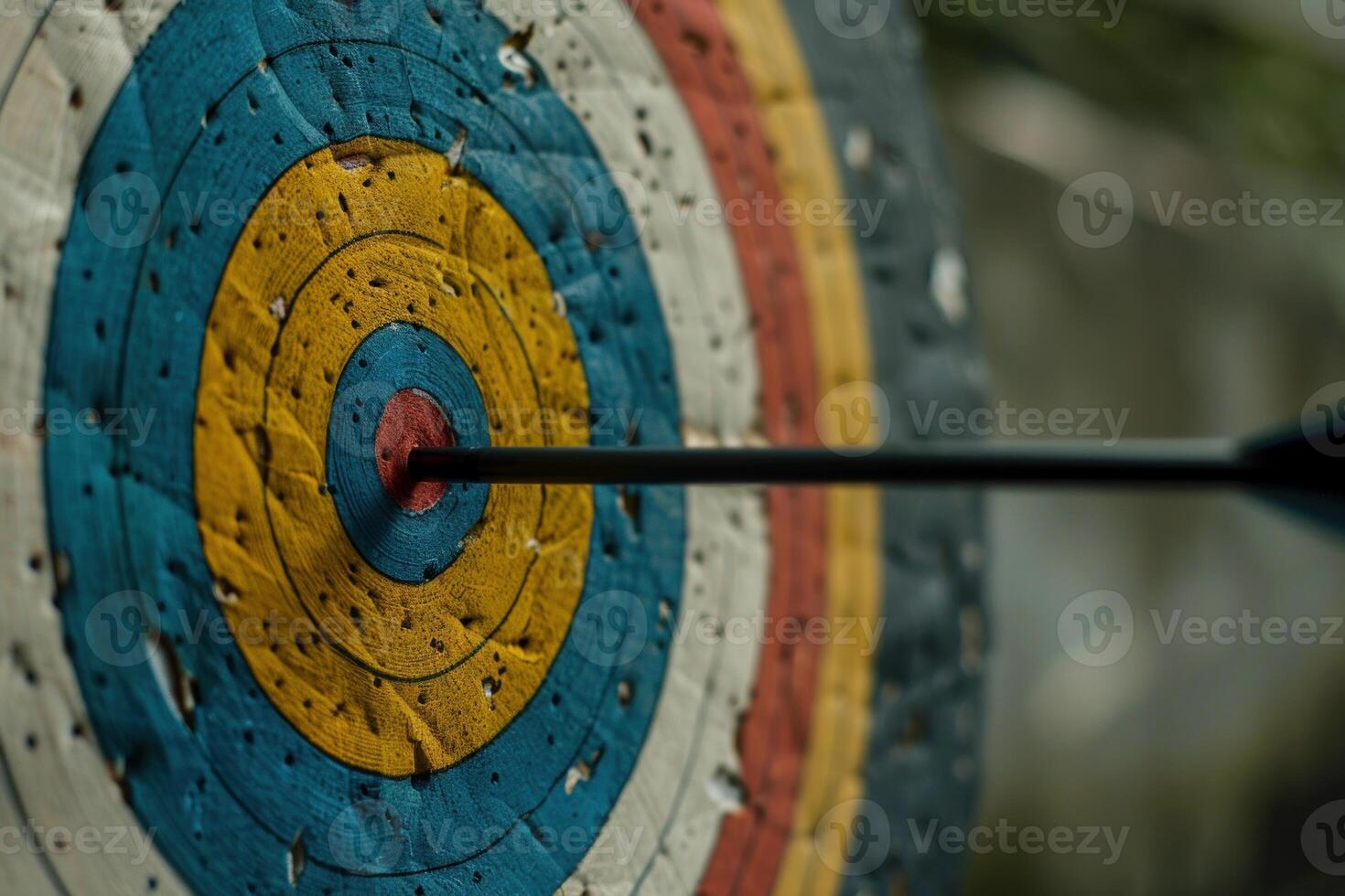 Black arrow hitting the center of colorful target photo