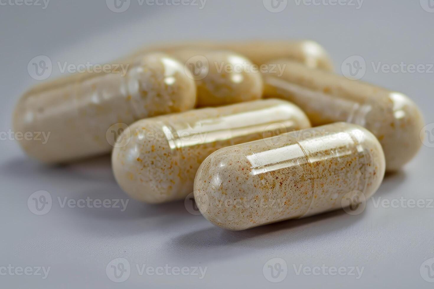 Herbal medicine capsules lying on neutral background photo