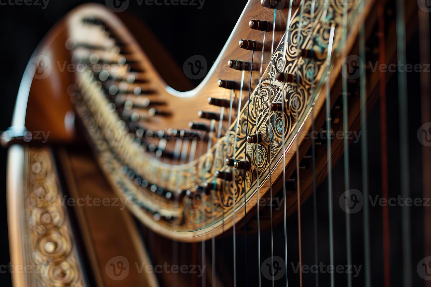 Close up of a harp with ornate carvings, highlighting the craftsmanship of string instruments photo