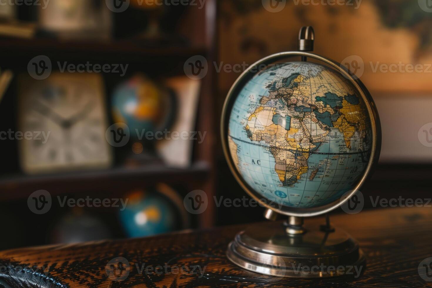 Vintage globe sitting on desk with antique globes in background photo