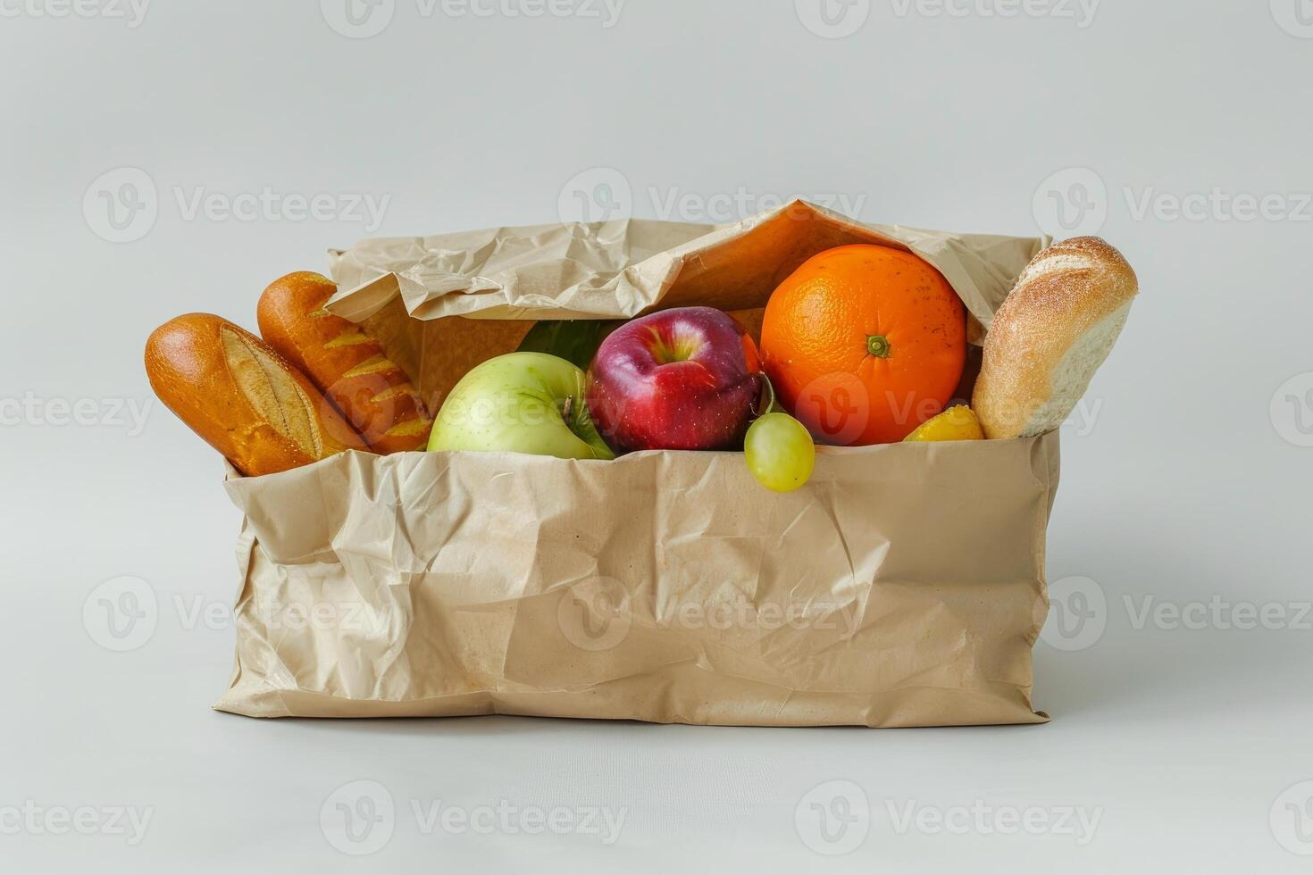 Paper bag overflowing with groceries on white background photo