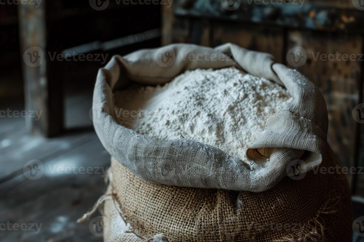 Open sack overflowing with white flour in mill photo