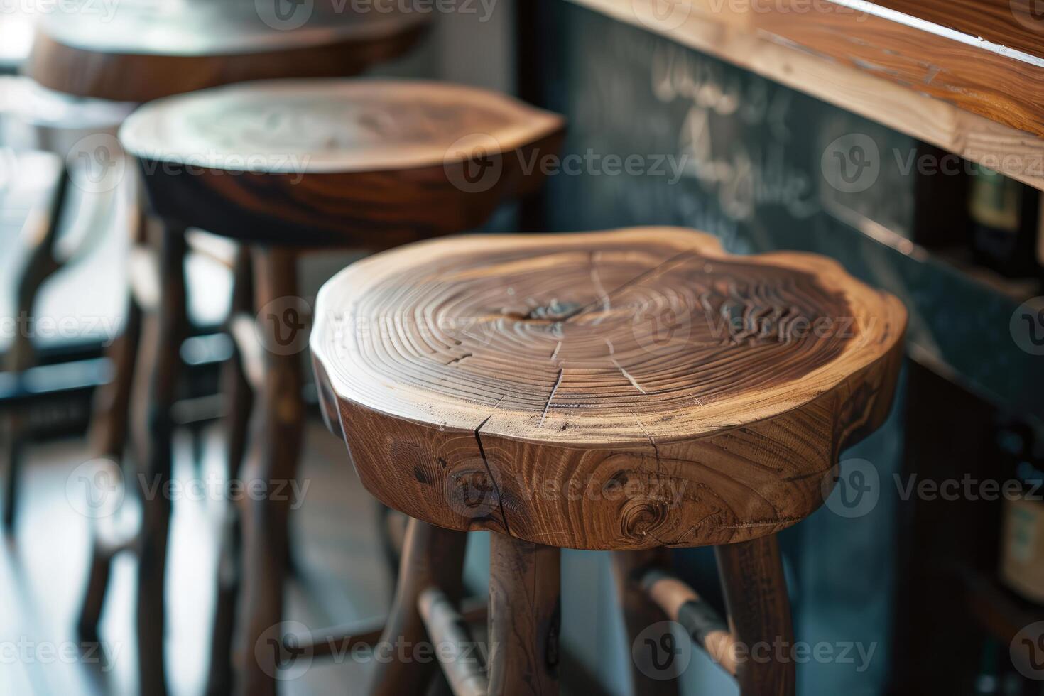 Row of wooden stools standing at a bar counter photo