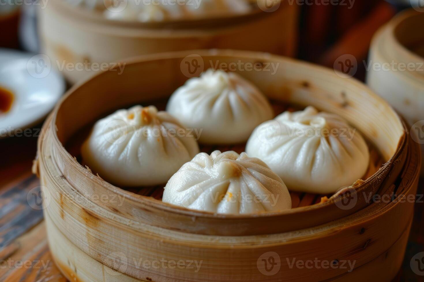 Steamed bao buns steaming in a bamboo steamer basket photo