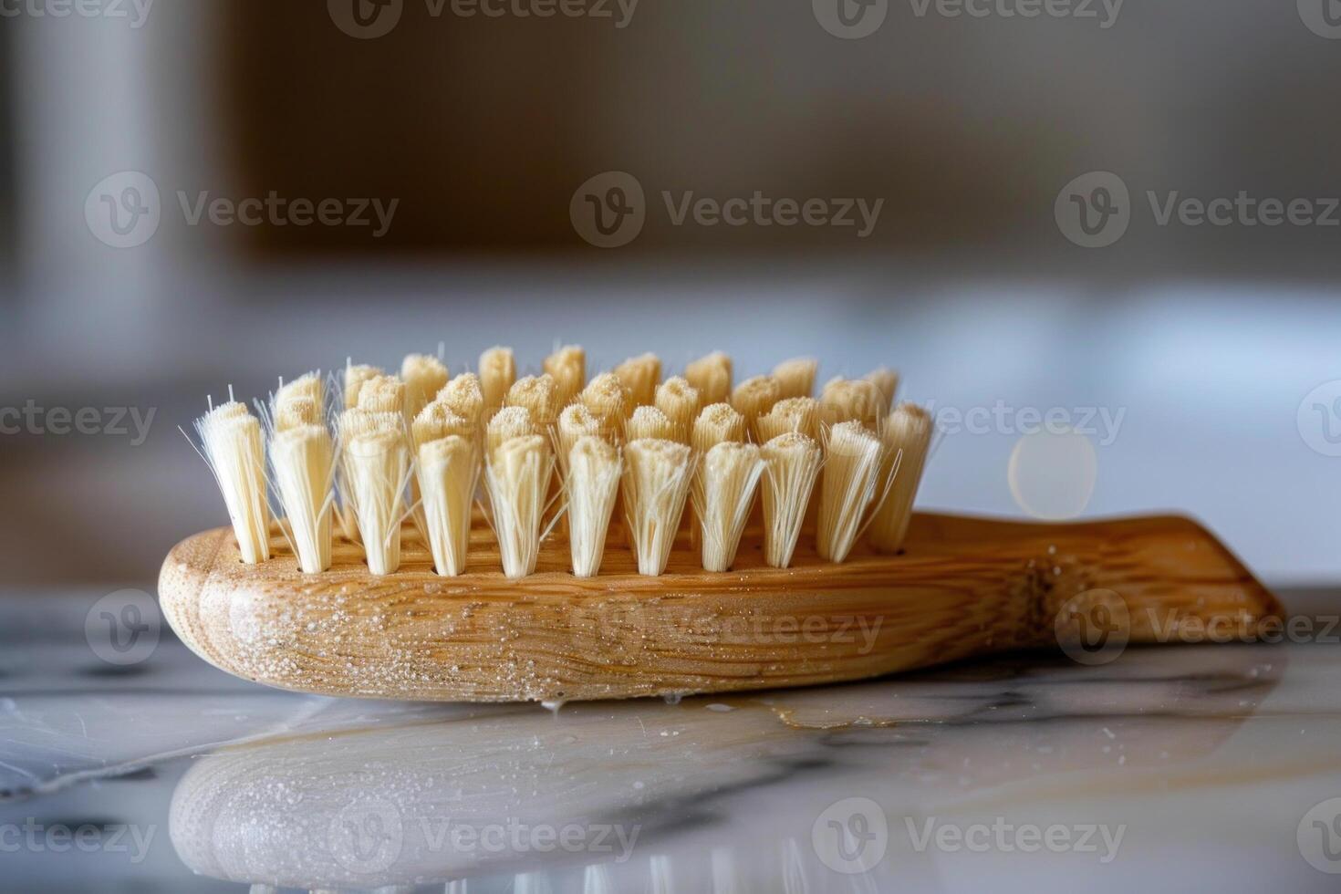 Natural bristle exfoliating body brush resting on marble countertop photo