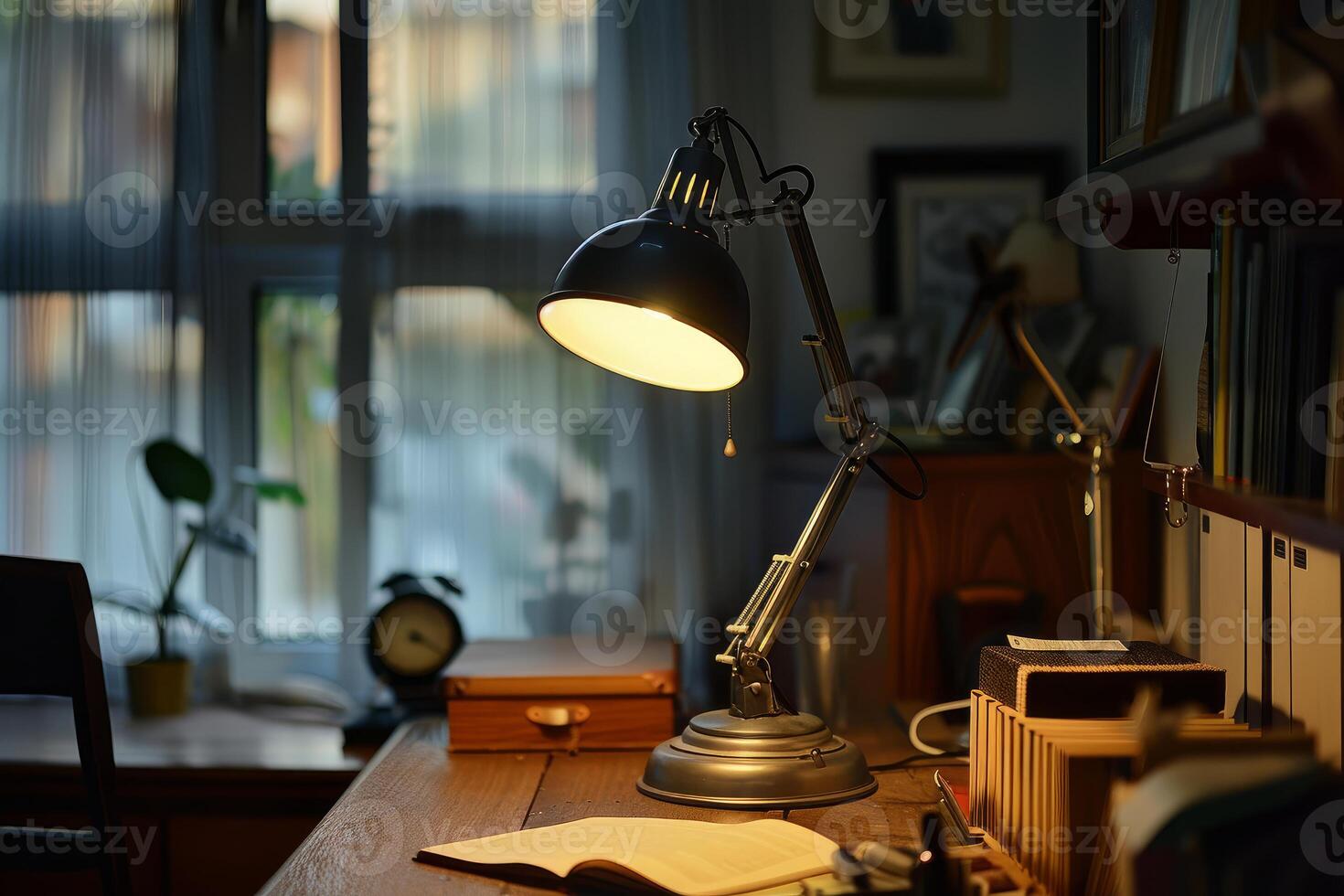 Desk lamp illuminating open book on desk at night photo