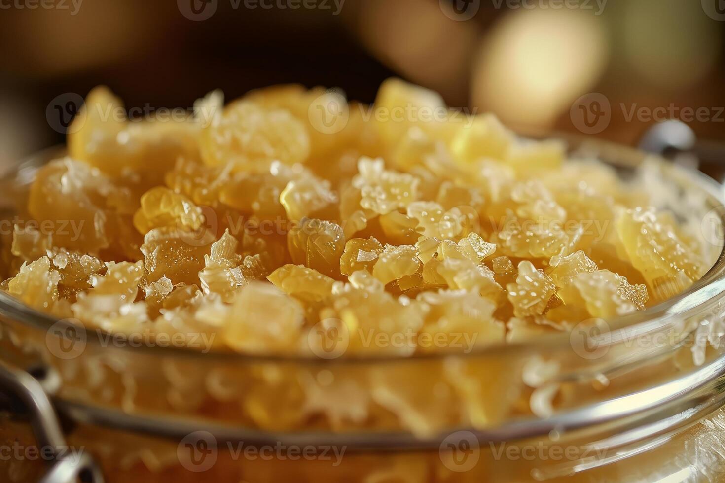 Close up view of crystallized honey in glass jar with metal clasp photo