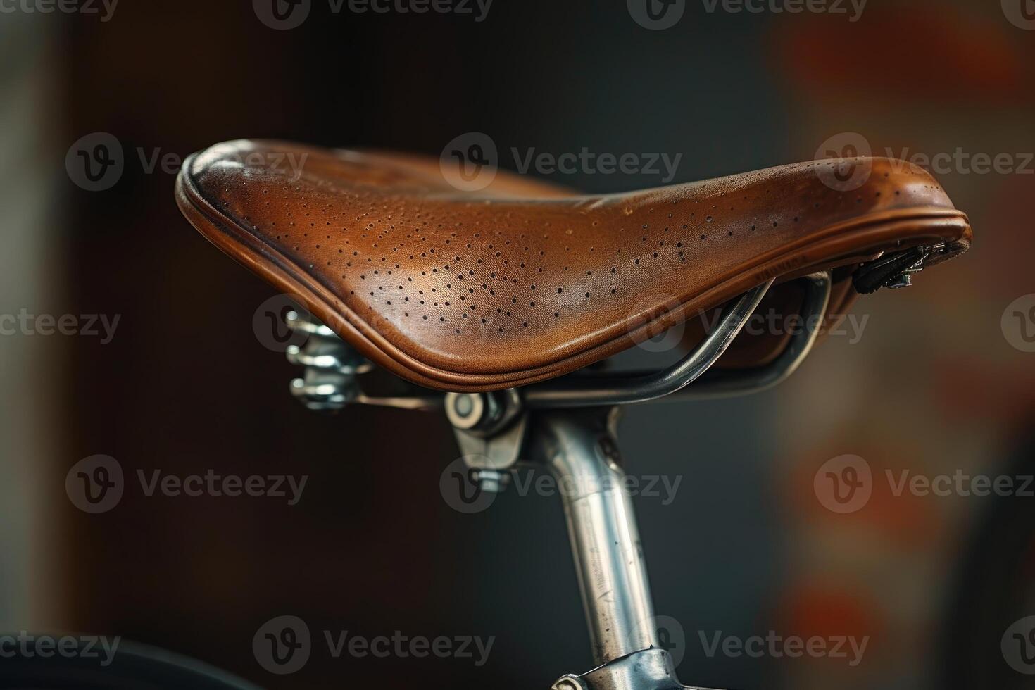 Brown leather bicycle saddle detail showing stitching and metalwork photo