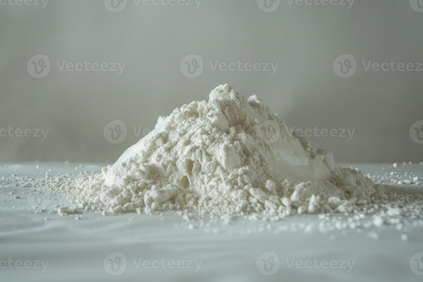 Pile of white flour is sitting on a white table photo