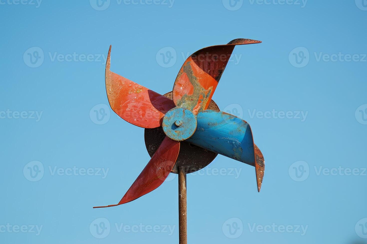 Colorful weathered metal windmill turning in the wind photo