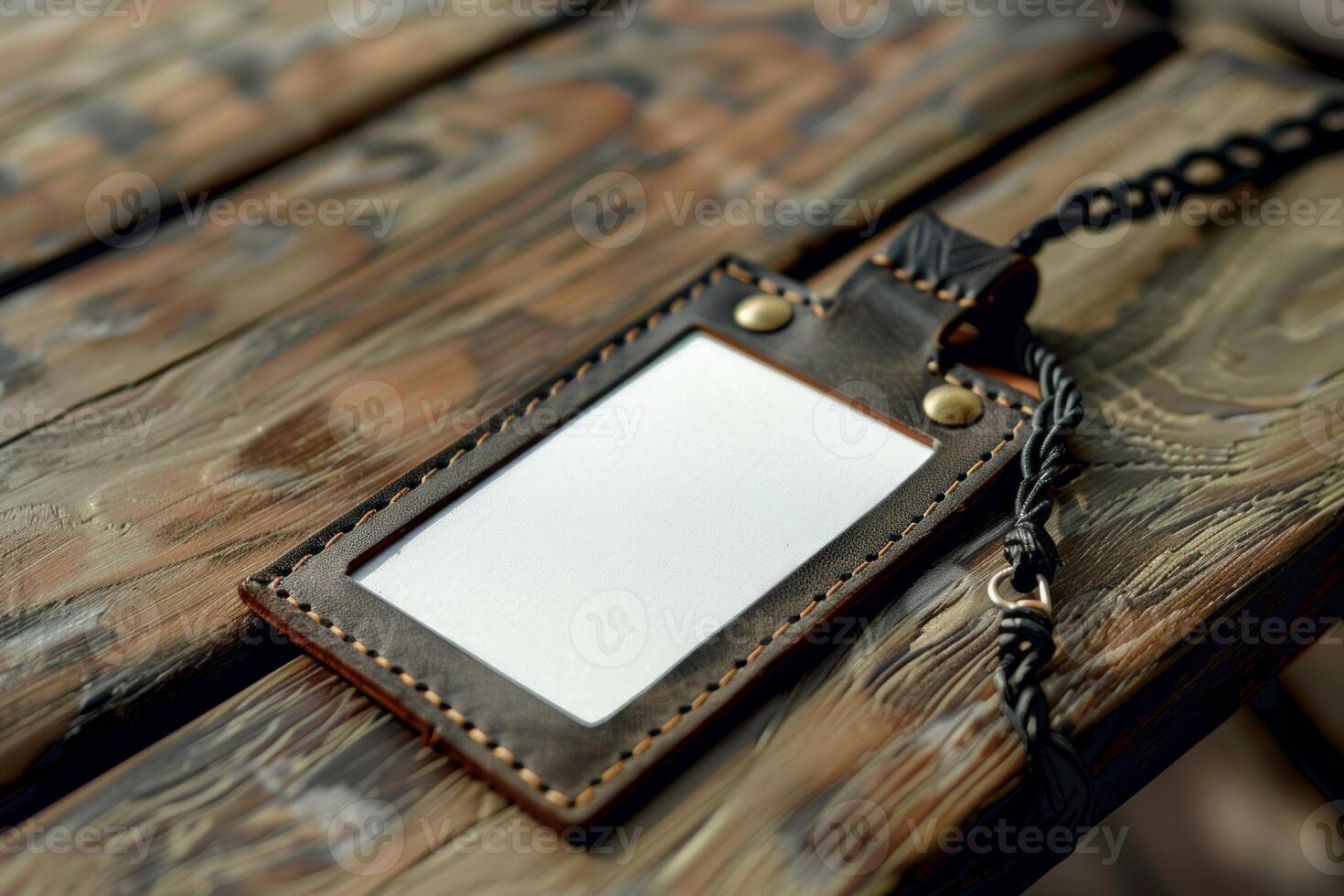 Blank leather badge holder lying on wooden table photo