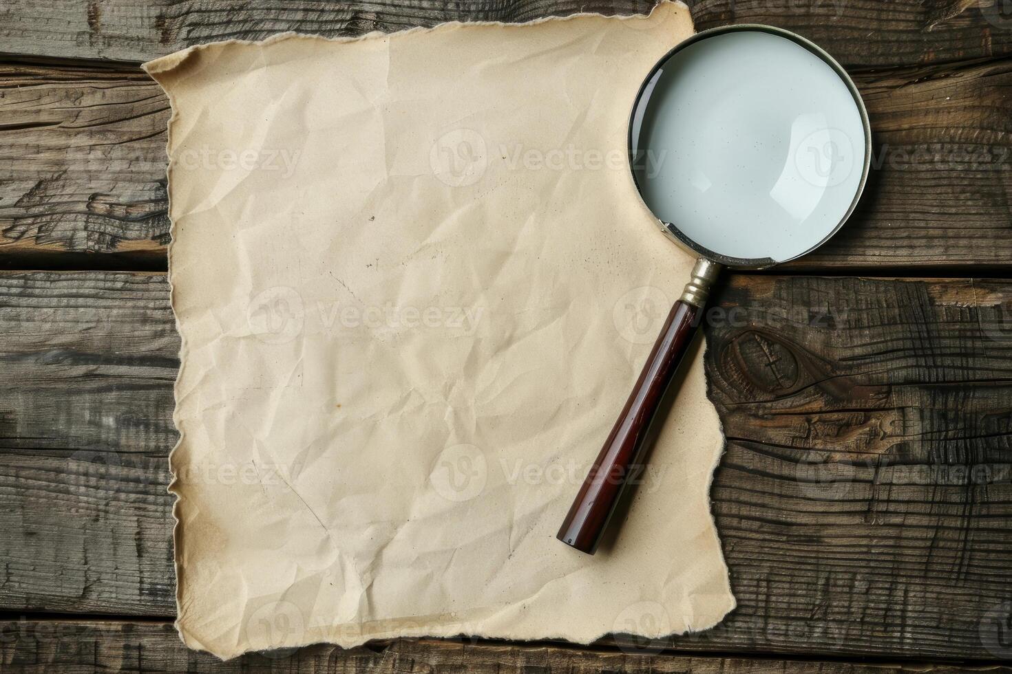 Vintage magnifying glass resting on aged parchment on wooden table photo