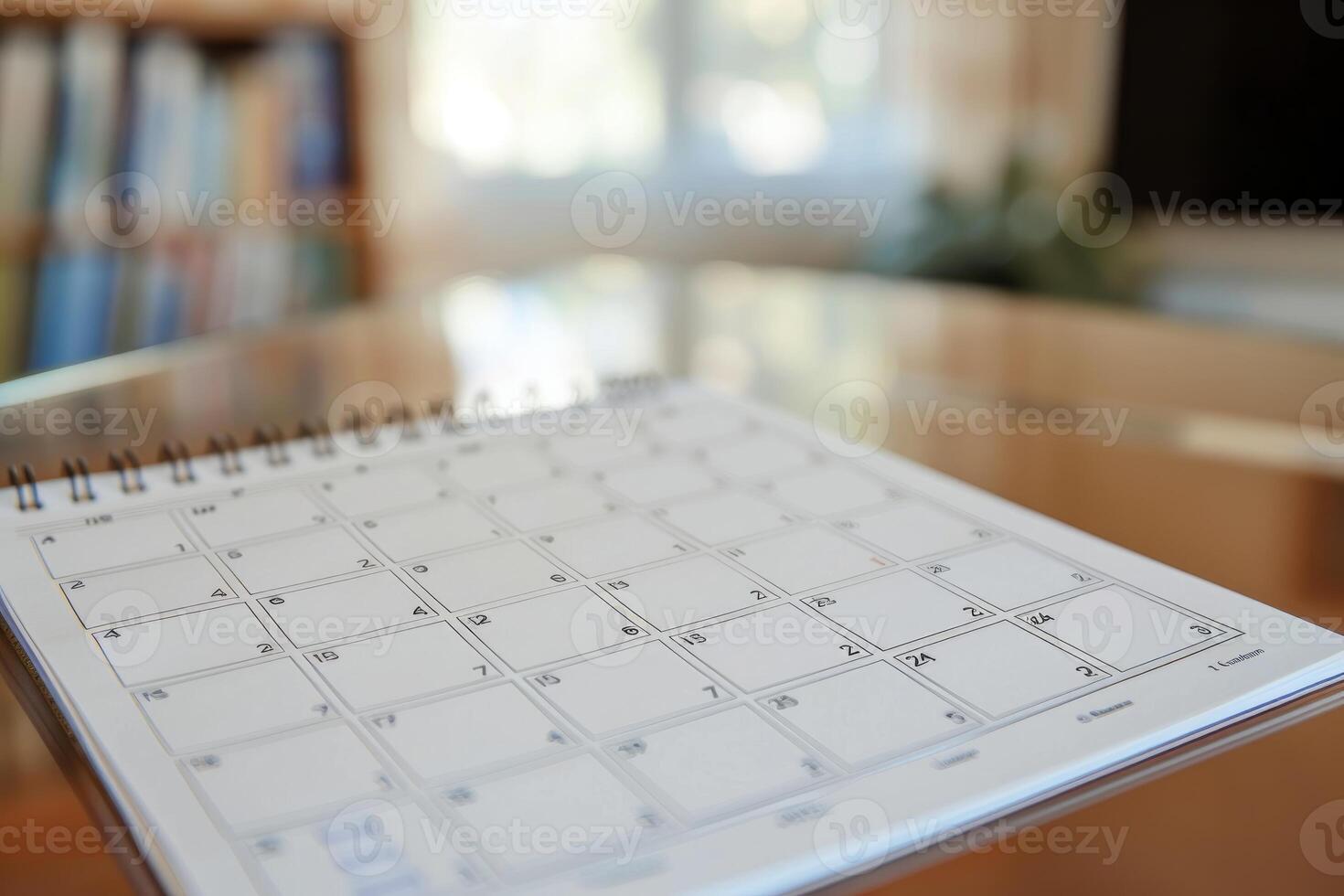 Open calendar showing empty dates sitting on glass table photo